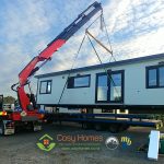 A Cosy Home being lifted by a Hiab