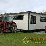 A Cosy Home being towed by a tractor