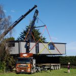 A Cosy Home in a dual lift by two Hiabs (being passed from one Hiab to the other in mid air)