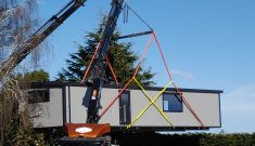 A Cosy Home in a dual lift by two Hiabs (being passed from one Hiab to the other in mid air)